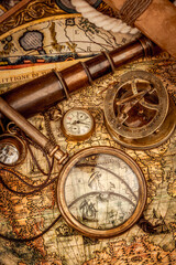 Vintage style travel and adventure. Vintage old compass and other vintage items on the table.