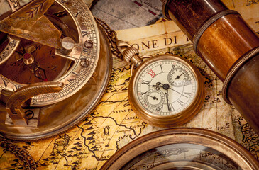 Vintage style travel and adventure. Vintage old compass and other vintage items on the table.
