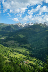 Georgia trekking routes. Magnificent Georgian mountains. Snowy and green mountains of Georgia. Svaneti mountains. Mountain landscapes in bloom in spring.