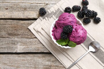 Delicious blackberry sorbet, mint and fresh berries on wooden table, top view. Space for text