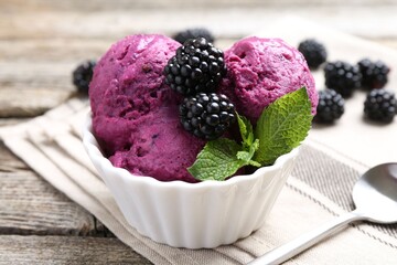 Delicious blackberry sorbet, mint and fresh berries on wooden table, closeup