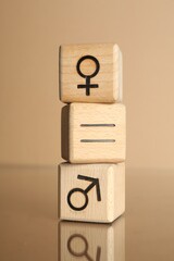 Gender equality concept. Cubes with male and female symbols on beige background