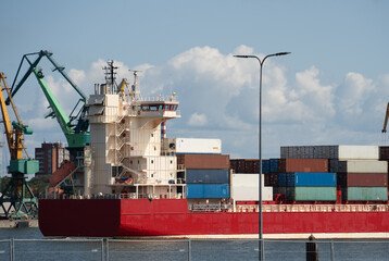 Containerised cargo ship against a blue sky