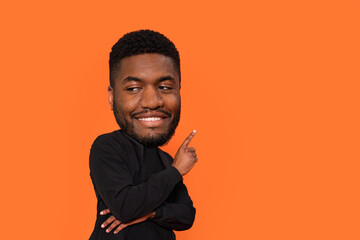 Playful Individual With Oversized Head Gestures Cheerfully Against Bright Orange Background