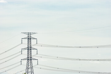 Electric poles and lines or high voltage towers at beautiful sky