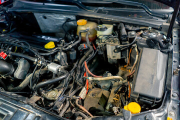 Fototapeta premium close-up in clean car service in the front of the car under the hood car power wiring system engine part full check up