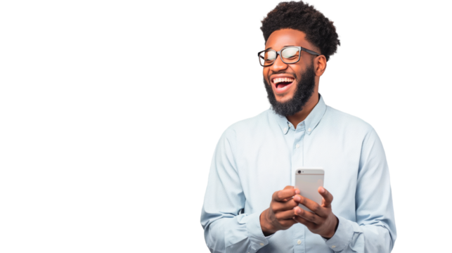 A cheerful man uses his cell phone, smiling as he enjoys a moment of communication or entertainment.