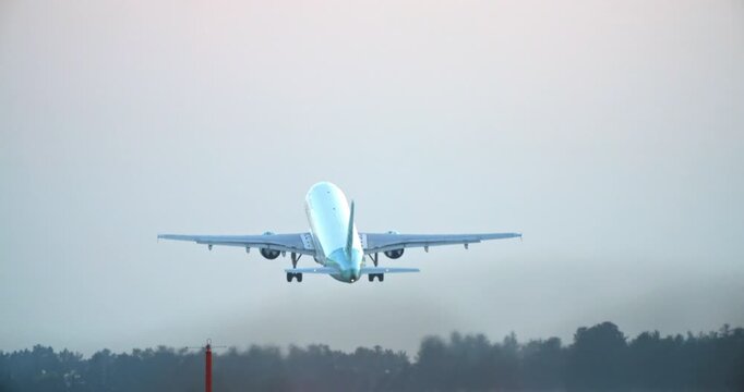 A passenger plane takes off into the sky from the airport runway. Flights and air transport travel by plane. High quality 4k footage
