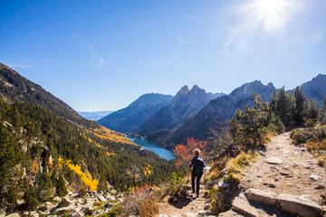 Fototapeta premium Young hiker woman in autumn in Aiguestortes and Sant Maurici National Park, Spain