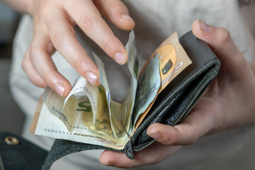 child holding wallet, takes out euro, theft money, managing pocket money, encouraging good...