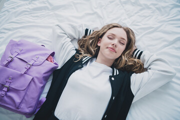 Photo of sweet pretty teen girl lying bed sleeping relax wear stylish school uniform morning...