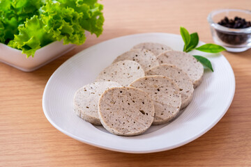 Vietnamese pork sausage or white pork sausage on white plate.