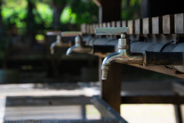 Rows of water faucets used for washing hands, in the outdoor