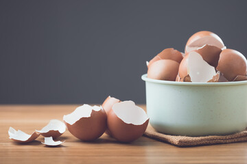 Pile of eggshells sits on a table against a gray background, symbolizing the potential benefits of...