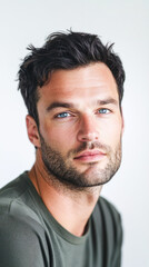 Fototapeta premium Man in green tee with relaxed expression