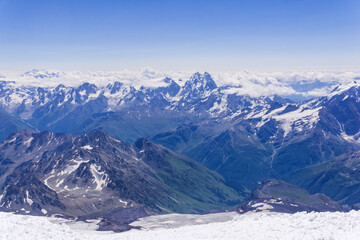 Obraz premium mountain landscape, view from highland snow slope to green valleys, view from Mount Elbrus to the Main Caucasian Range