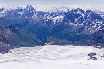 mountain landscape, view from highland snow slope to green valleys, view from Mount Elbrus to the Main Caucasian Range