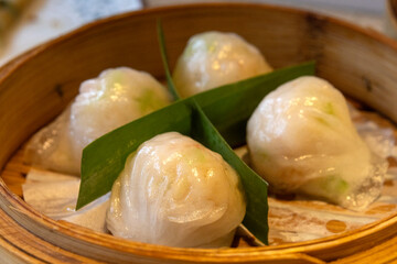 Dim sum Hargao steamed shrimp dumplings in bamboo basket container,