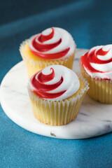 Tasty cupcakes with cream cheese frosting. Homemade muffins top view