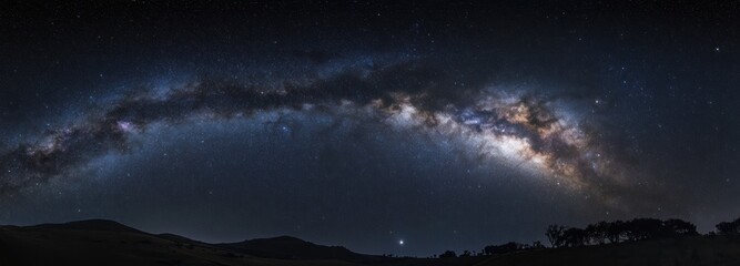 Naklejka premium Milky Way Galaxy Over Silhouetted Hills and Trees