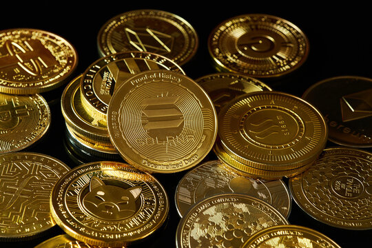 Collection of Various Cryptocurrency Coins Displayed on a Black Surface