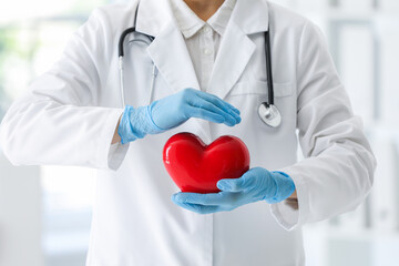 Doctor with red heart in clinic, closeup