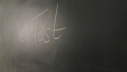 Close up of woman hand wiping text math test on chalkboard, professor writes on blackboard or student solving task. Education and science concept.
