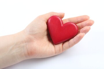 Woman holding red heart on white background, closeup