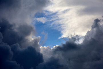 Sky with break into dark storm and white clouds. Dramatic background for weather before rain