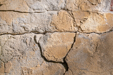 A crack on the stone wall of a building.