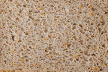 A piece of black bread, close-up. Porous texture of yeast bread.