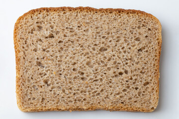 Slices of black bread on a white background, close-up.
