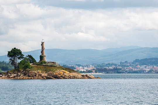 Lighthouse of the Tambo Island as seen from a boat in the Ria de Pontevedra in Galicia, Spain. Formerly a Naval Military School base, since 2022 it serves as a natural and cultural destination.