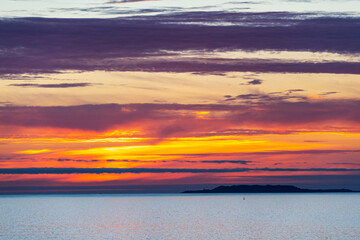 Silhouette of the Galician coast at the opening of the Ria de Pontevedra and the Ria de Arousa at dusk, were the Atlantic ocean meets the land.
