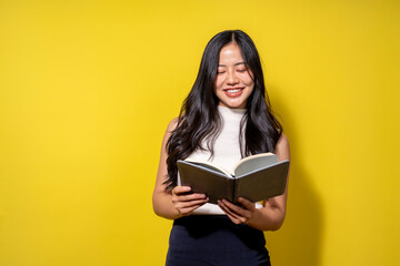 A woman is reading a book and smiling