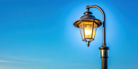 Modern street lamp glowing against clear blue sky, urban, city, lighting, electricity, technology, design