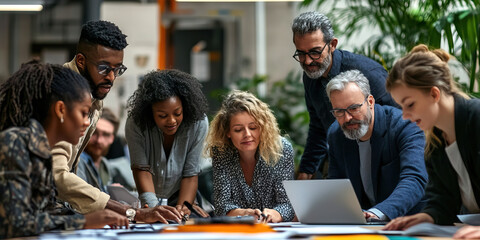 Multiethnic group of people, including people of color, working together in an open-plan office setting.