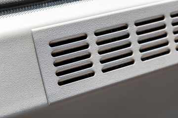 Simple clean metal air vent, air conditioning outlet holes, public transport vehicle train bus metro or industrial air duct part detail closeup, nobody. Cleaning, servicing AC systems simple concept