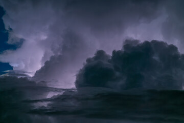 A full moon reflects the vast sea of clouds, creating a peaceful scene like ocean waves. The sky was filled with stars and sudden lightning flashes. Xindian District, Taiwan.