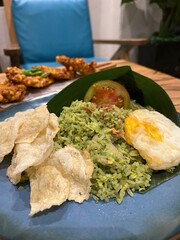 A plate of food with rice, tomatoes, and eggs