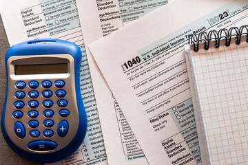 1040 TAX form blank on a calculator.  Individual Income Tax Return