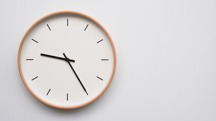 Minimalist wooden Wall Clock on White Wooden Surface with Space for Text – Time Set at 21.25, 09.25
