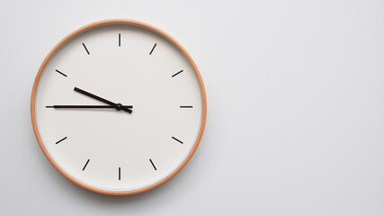 Minimalist wooden Wall Clock on White Wooden Surface with Space for Text – Time Set at 21.45, 09.45