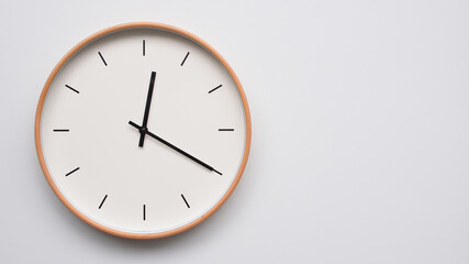 Minimalist wooden Wall Clock on White Wooden Surface with Space for Text – Time Set at 00.20/12.20