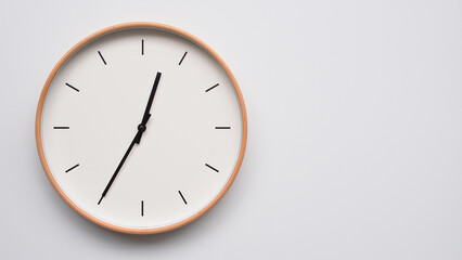 Minimalist wooden Wall Clock on White Wooden Surface with Space for Text – Time Set at 00.35/12.35