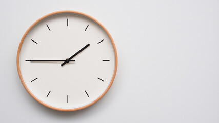 Minimalist wooden Wall Clock on White Wooden Surface with Space for Text – Time Set at 13.45/01.45