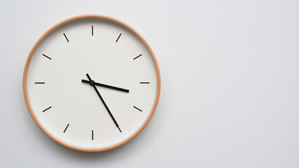 Minimalist wooden Wall Clock on White Wooden Surface with Space for Text – Time Set at 15.25/03.25