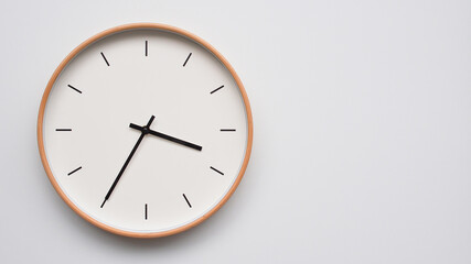 Minimalist wooden Wall Clock on White Wooden Surface with Space for Text – Time Set at 15.40/03.40