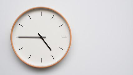 Minimalist wooden Wall Clock on White Wooden Surface with Space for Text – Time Set at 16.45/04.45