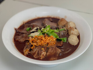 A captivating image of a bowl of noodles, beautifully presented with a variety of fresh ingredients and garnishes. The rich textures and vibrant colors make it an enticing visual for food enthusiasts